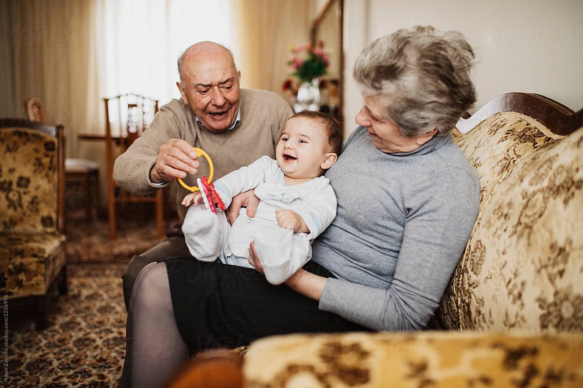 grandparents on a couch with a baby