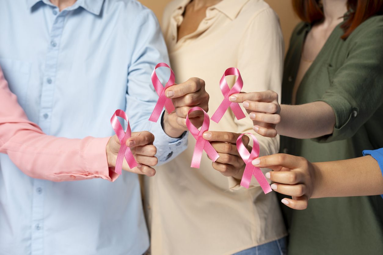 Support group holding pink ribbons