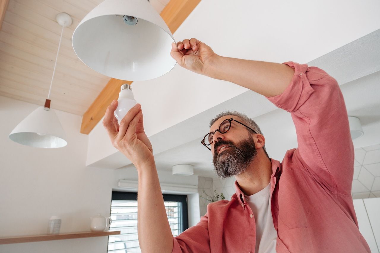 Man replacing a light bulb