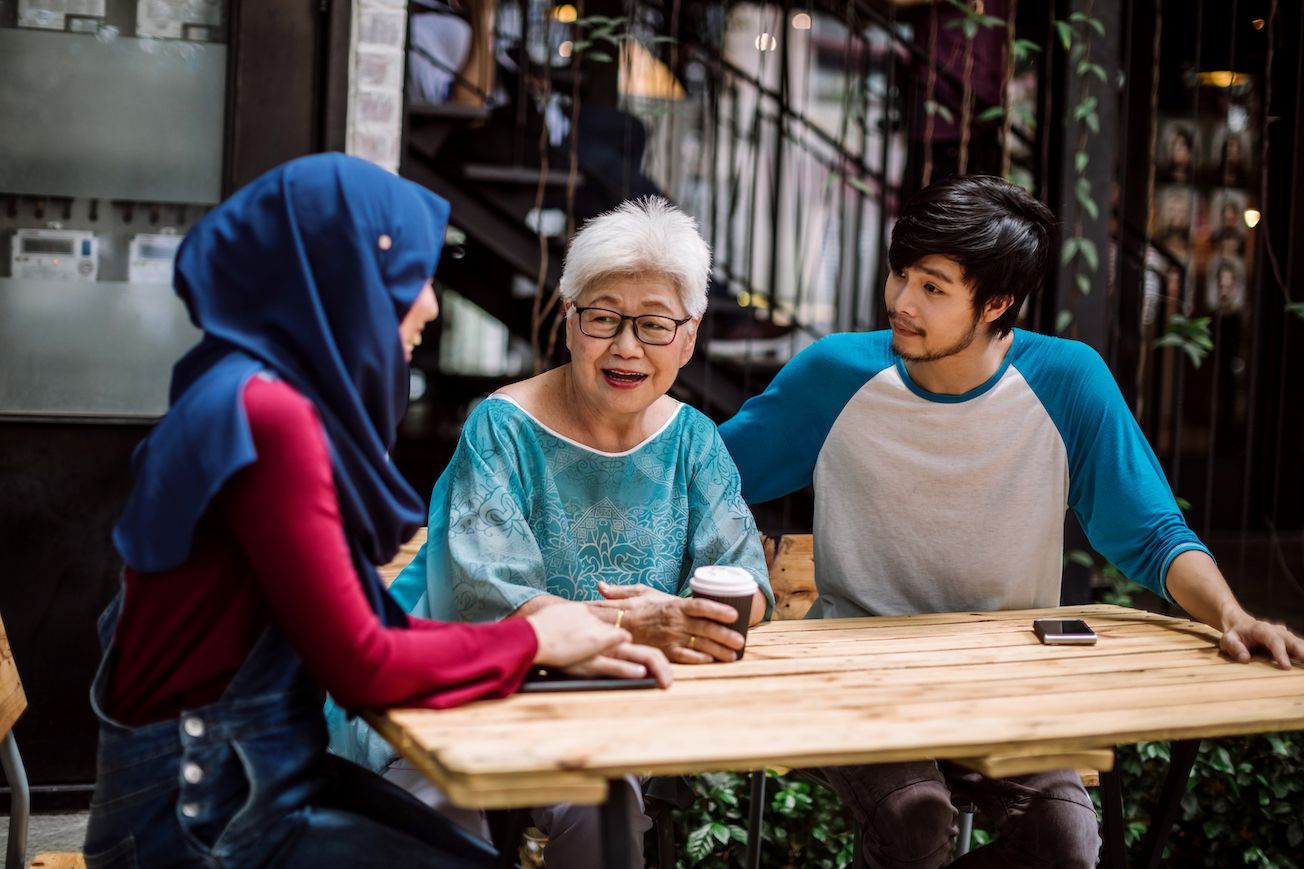 adult-children-talking-with-older-adult-parent-at-table