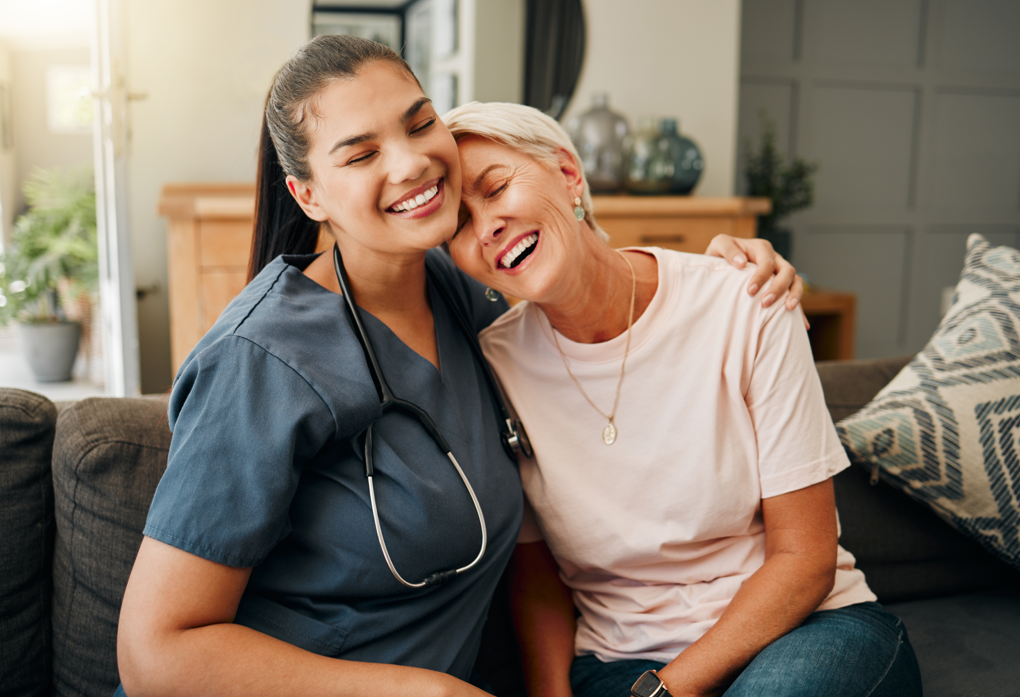 Nurse and Woman Hugging on Couch
