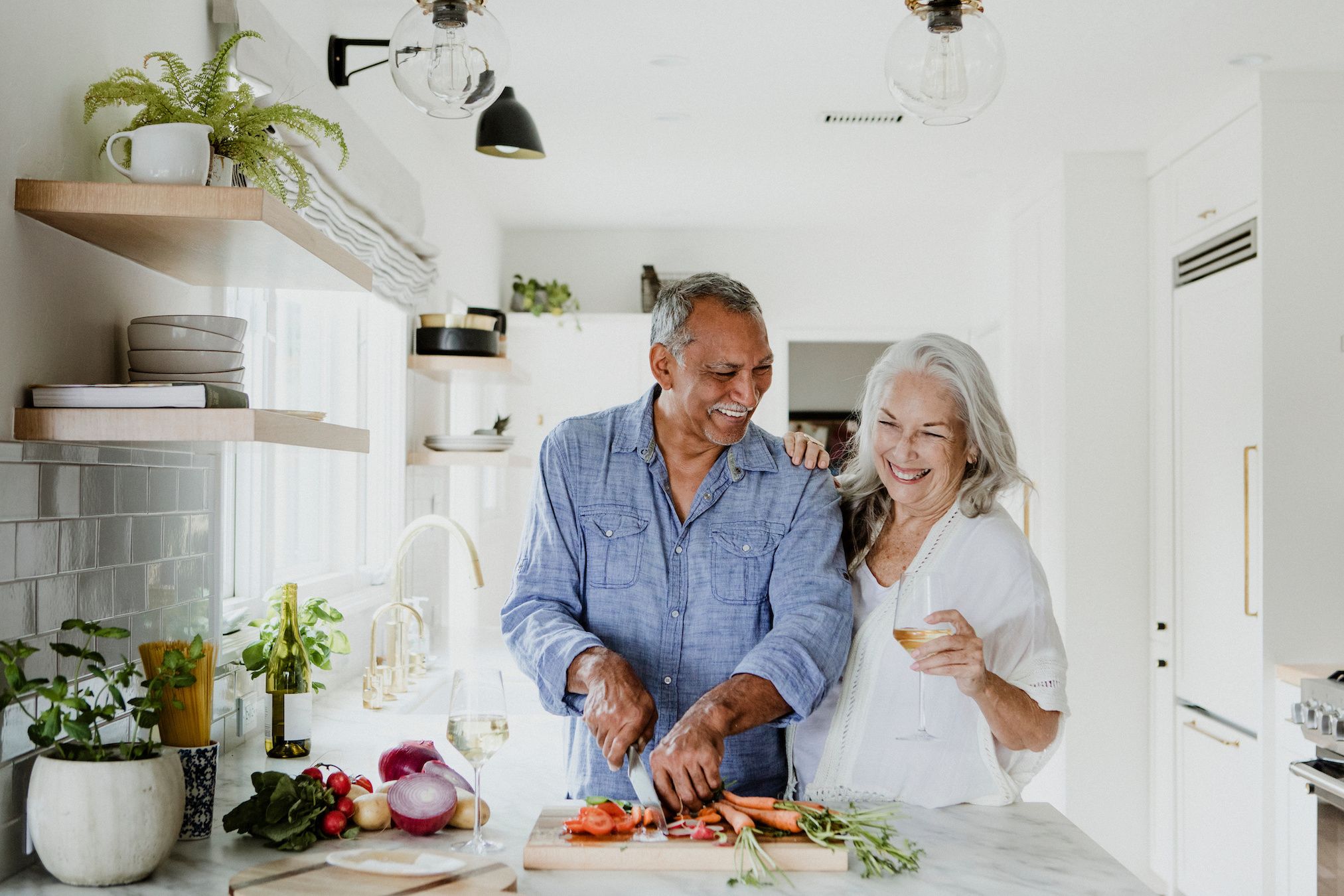 older couple cooking in ktichen
