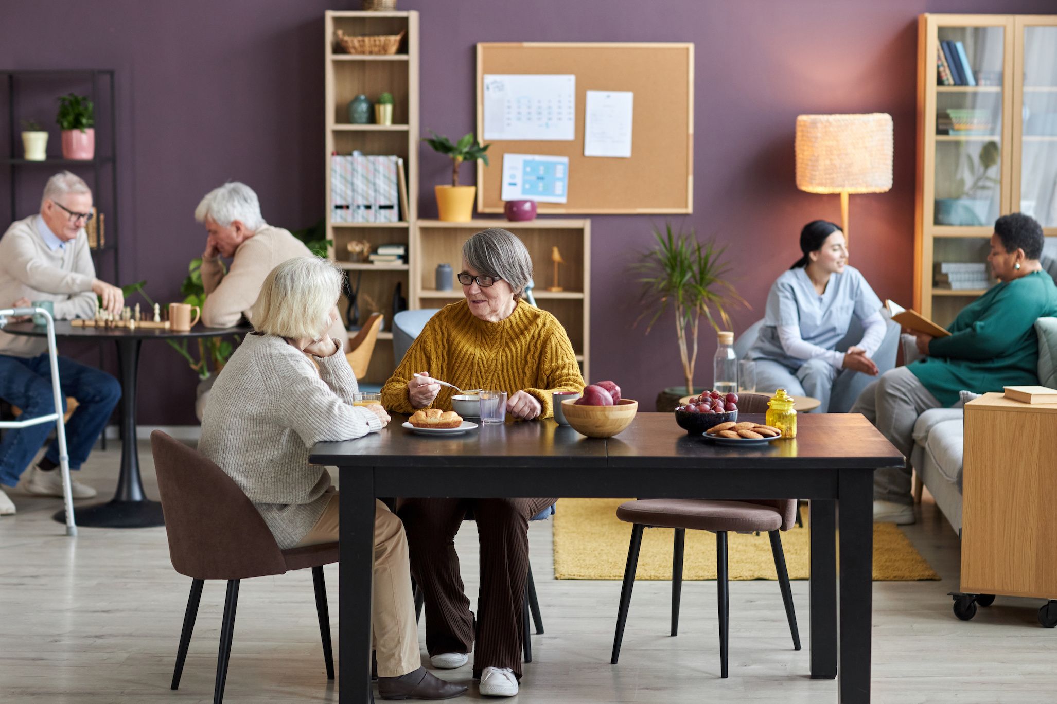 older adults eating at table and talking