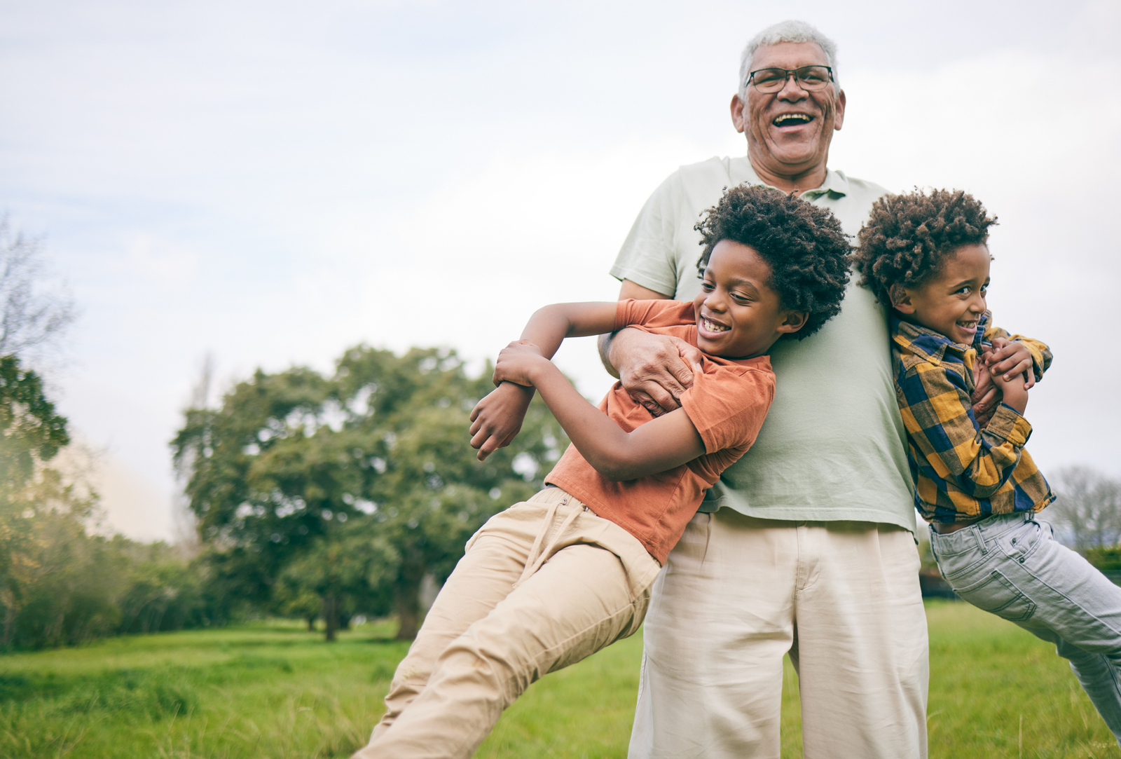 Older Man Swinging Two Kids