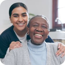 Older Woman and Caregiver Smiling
