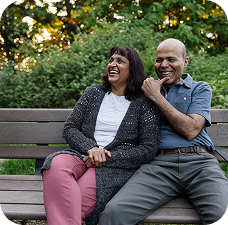 Middle Age Couple Smiling on Bench