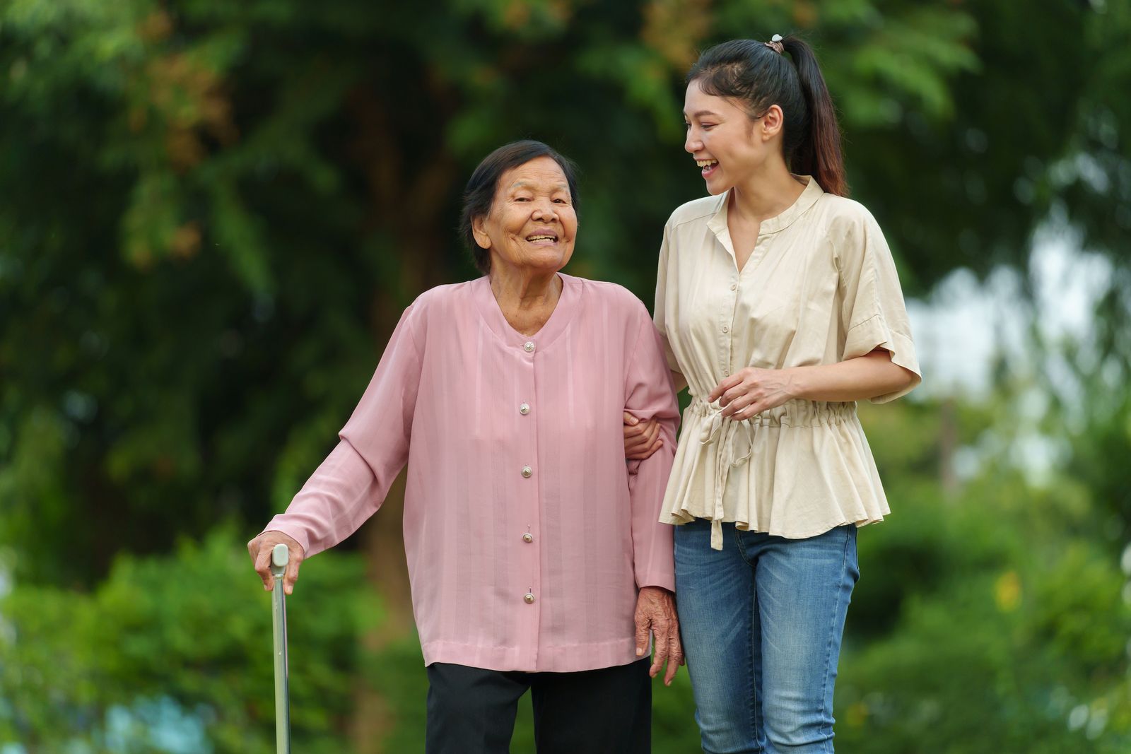 older-adult-using-cane-walking-with-adult-child