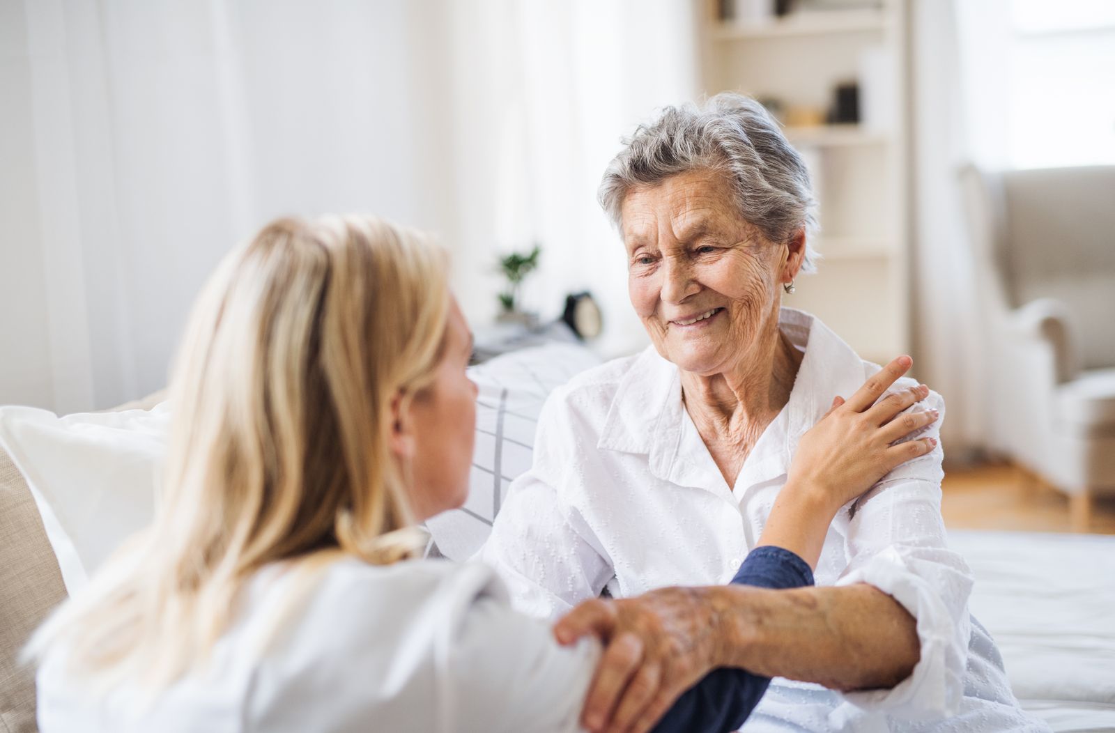 older-adult-woman-embracing-caregiver