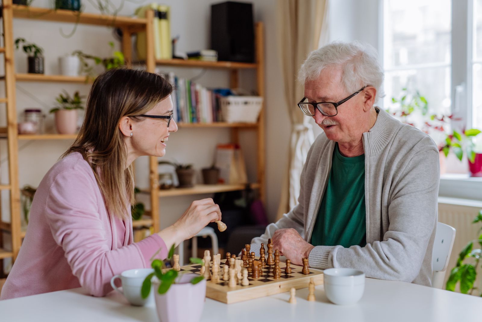 adult-child-playing-chess-with-older-adult-parent
