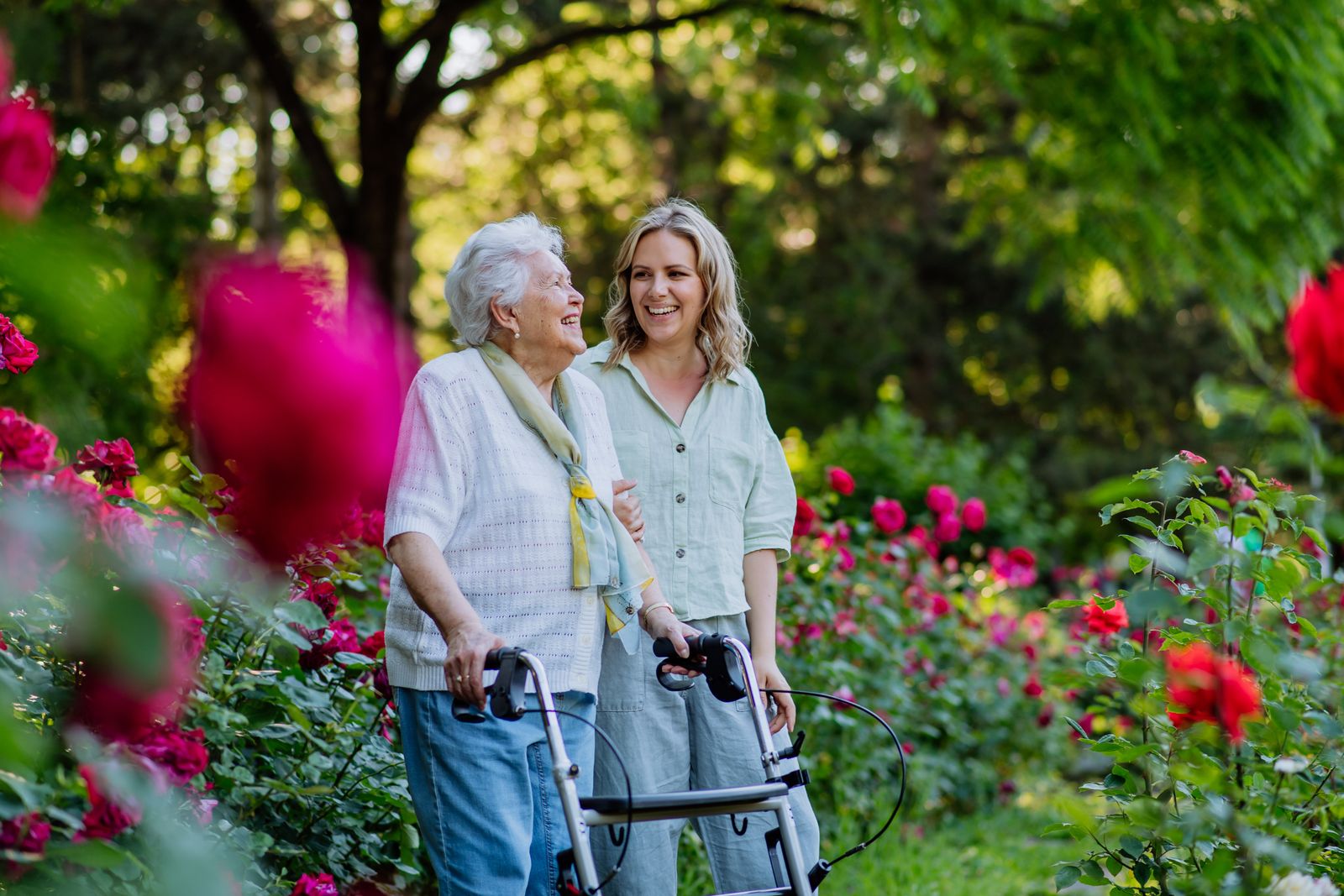older woman and adult child walking in garden