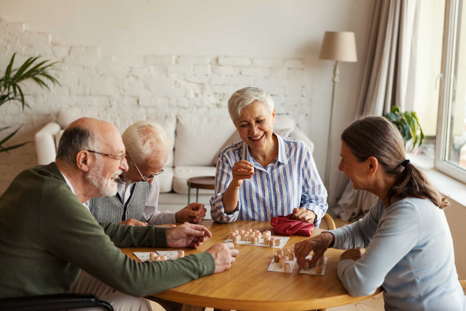 older couples sitting at a table playing a game