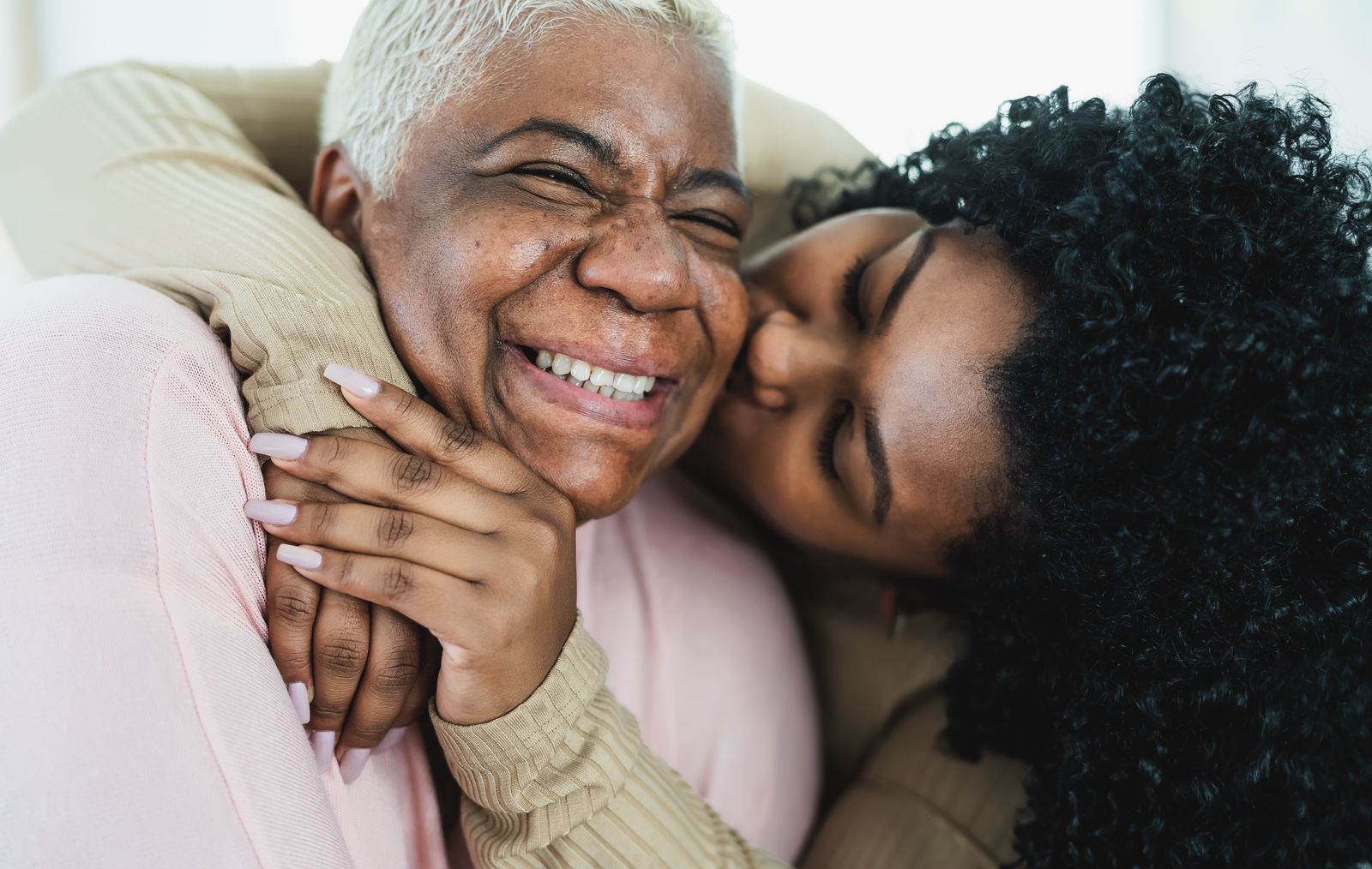 Younger Woman Kissing Older Woman on the Cheek