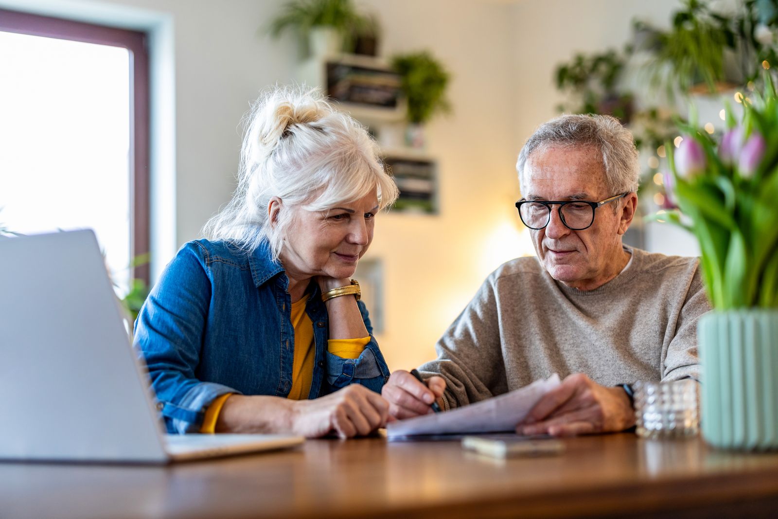 older adult couple reading at table