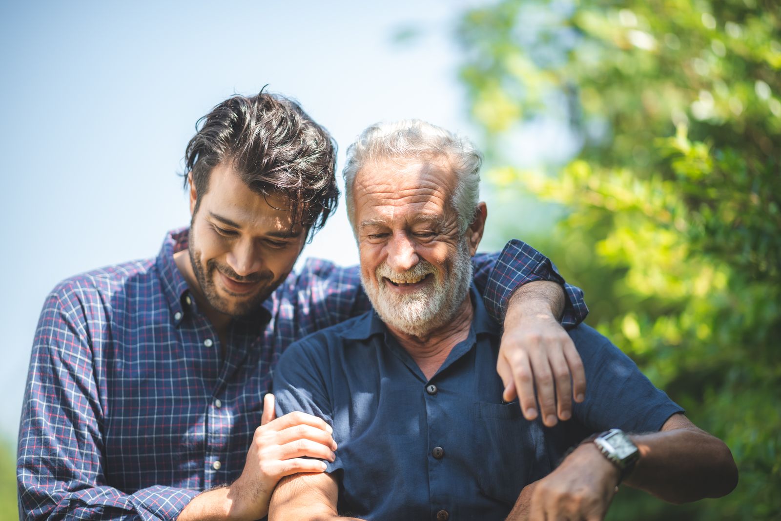 Adult-child-and-older-adult-embracing-outside-on-a-walk