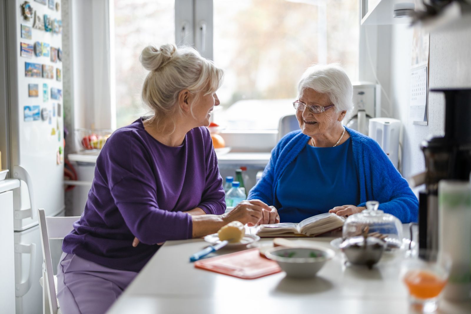 Two women talking at kitchen table