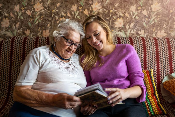 older woman and her daughter looking at photos