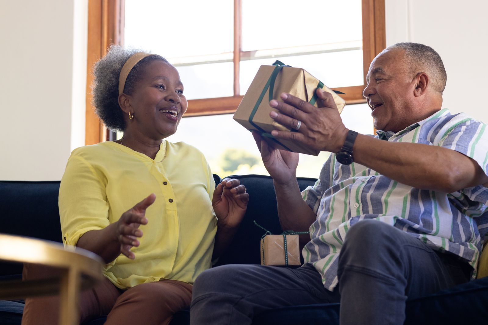 older_adult_giving_gift_to_caregiver