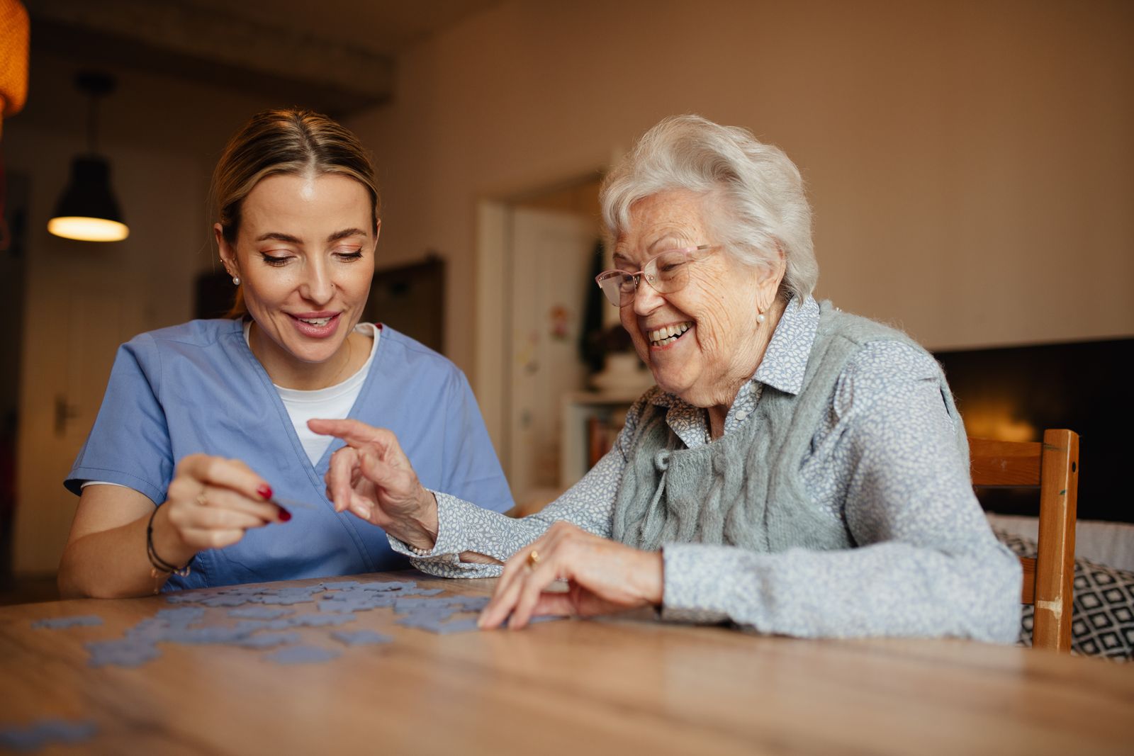 caregiver and older adult solving puzzle