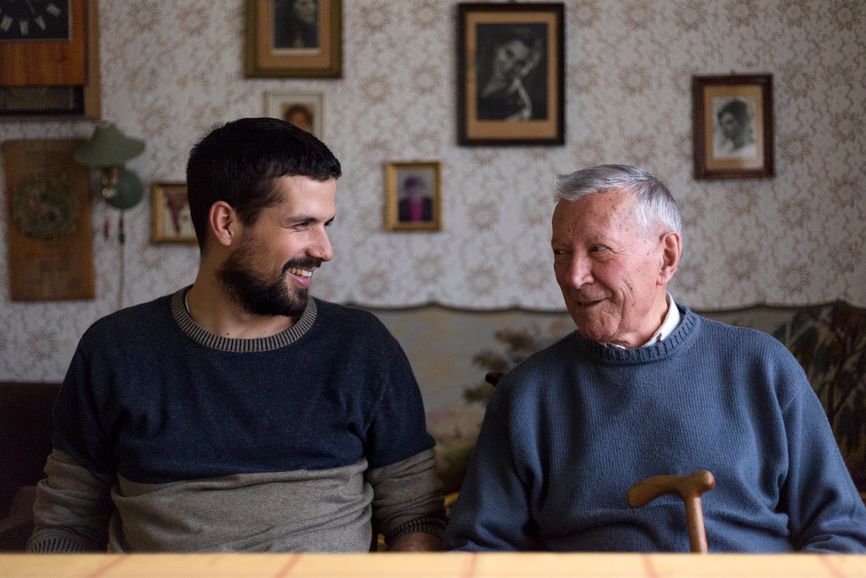 adult child and older man laughing