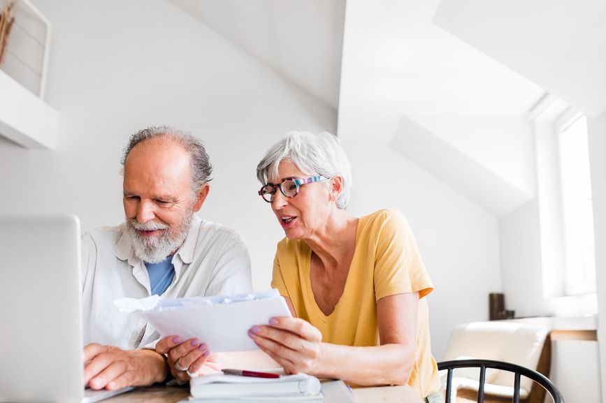 older couple researching on a computer