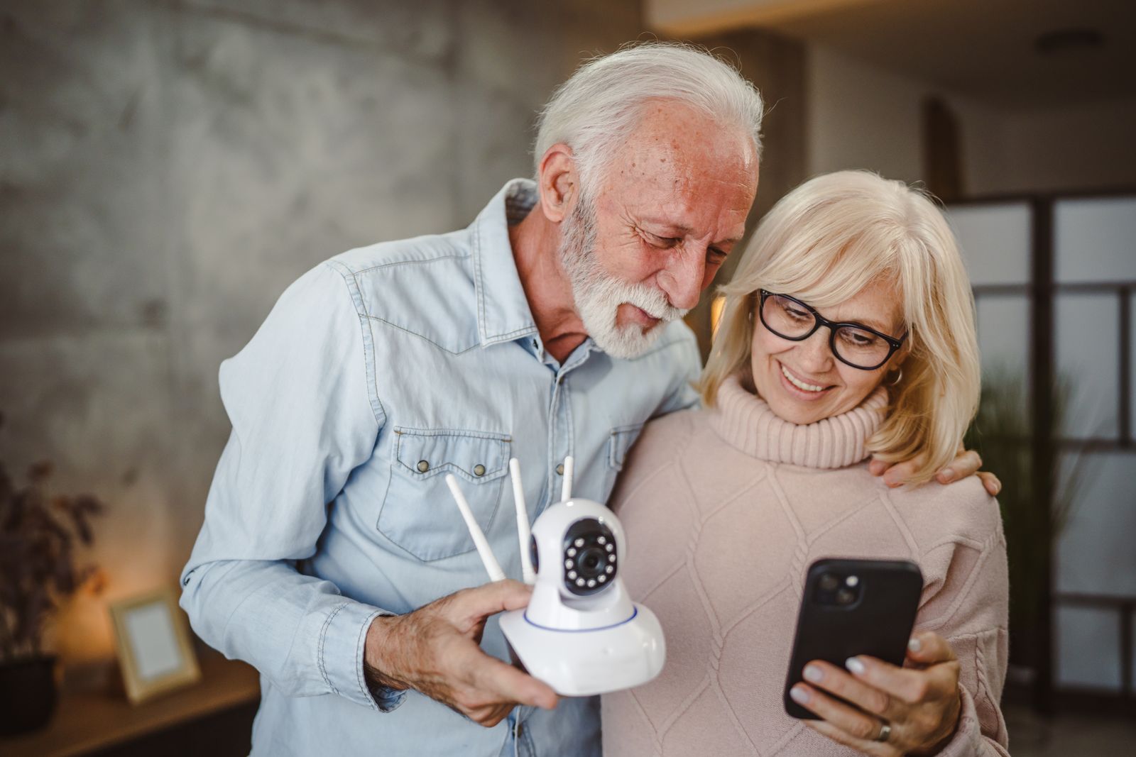 older-adult-couple-holding-smart-technology